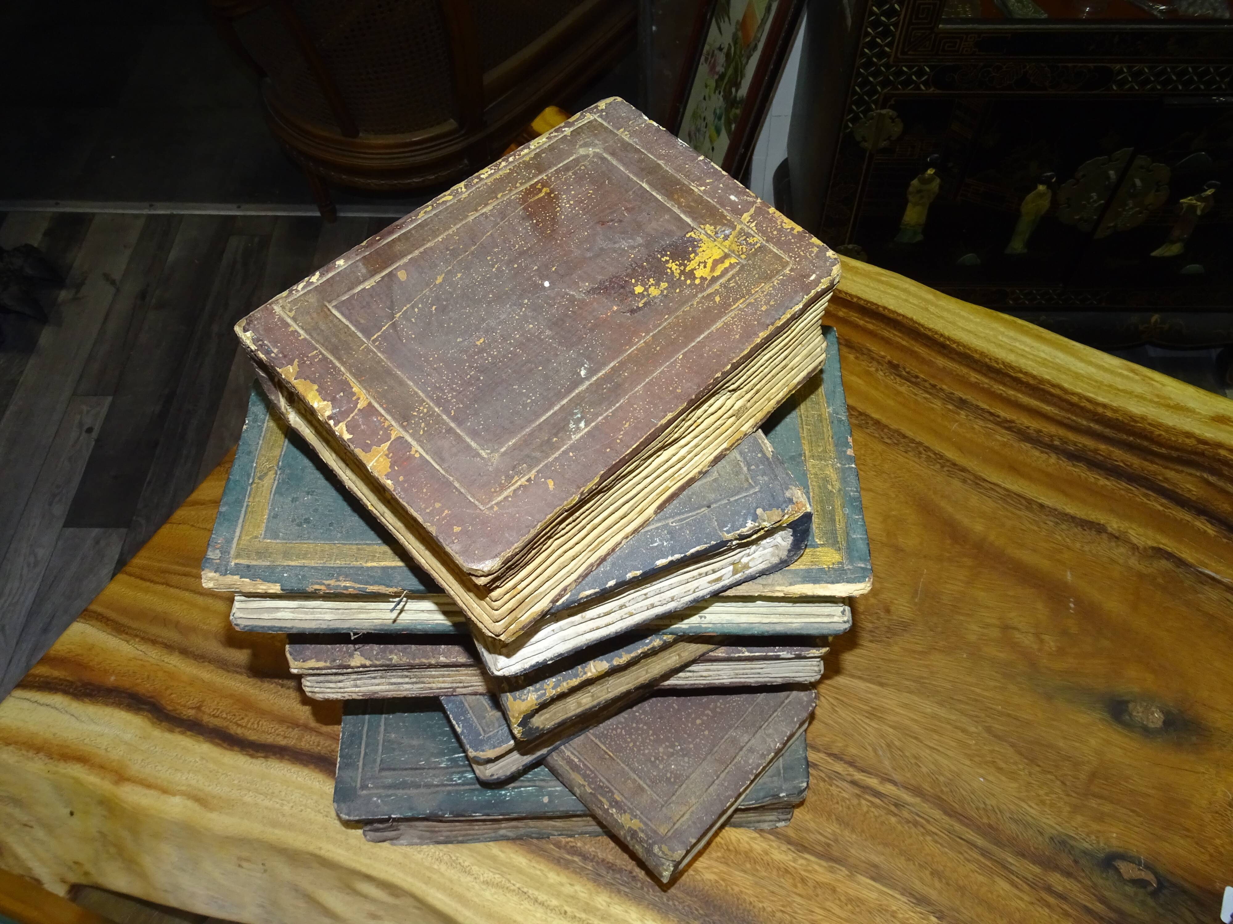 side table, end of sofa stack of wooden books, old, beautiful patina