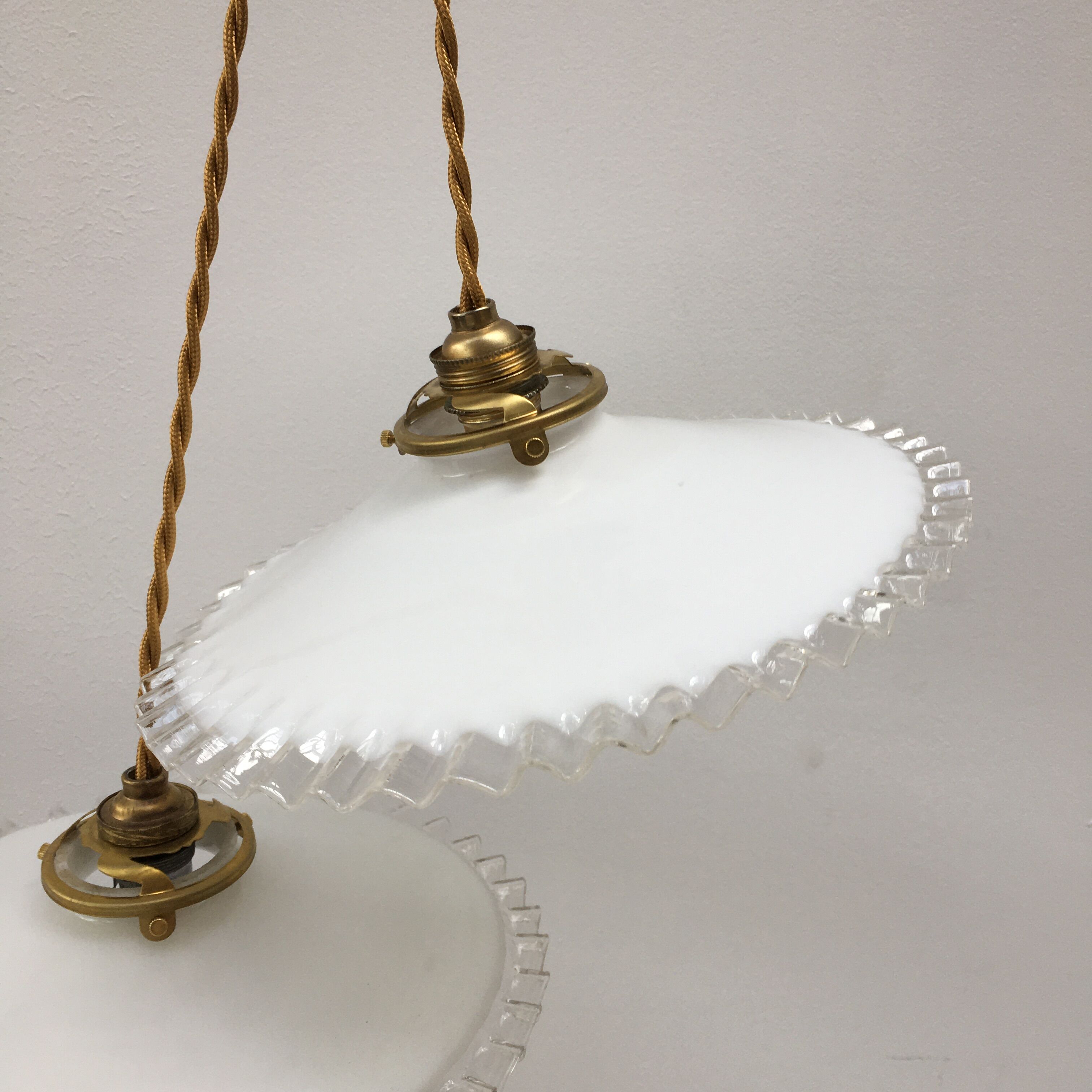 Pair of white opaline suspensions with serrated edges