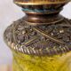 Vintage lamp with bronze imitation base & green relief glass in an antique style.