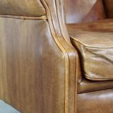 Graceful, stylish, timeless and comfortable wing chair made of cowhide in English style