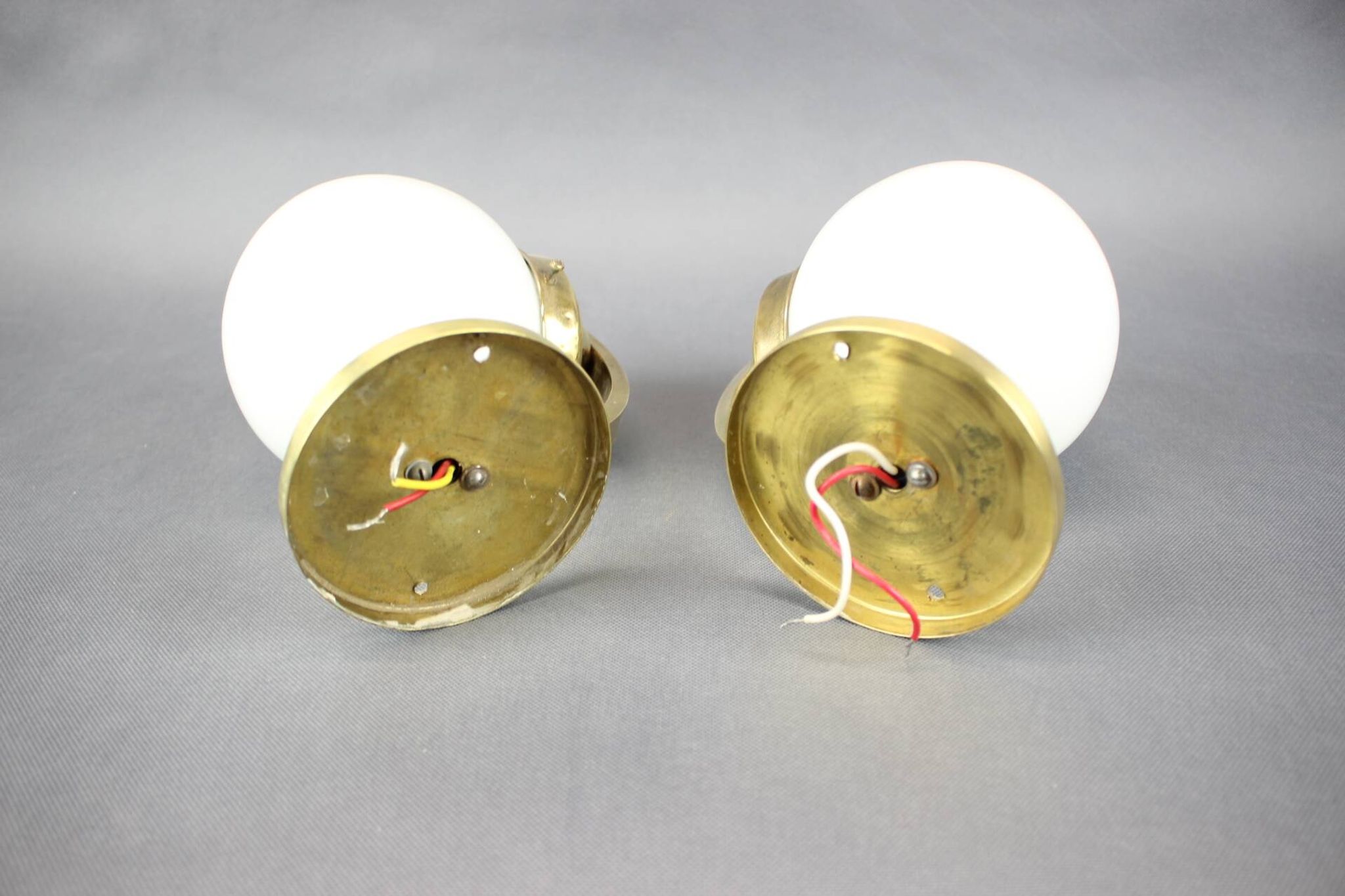 Pair of Art Deco wall sconces in brass and opaline glass, Europe, 1930s