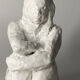 White ceramic seated sculpture