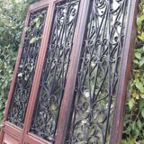 Porte d’entrée vitrée en chêne et grilles en fer, XIXème s.