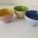 Set of three pastel two-tone mini bowls in glazed ceramic.