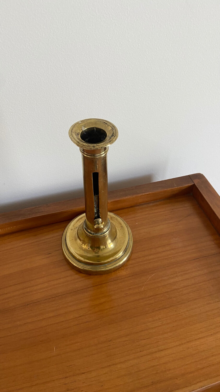 Old brass push candle holder