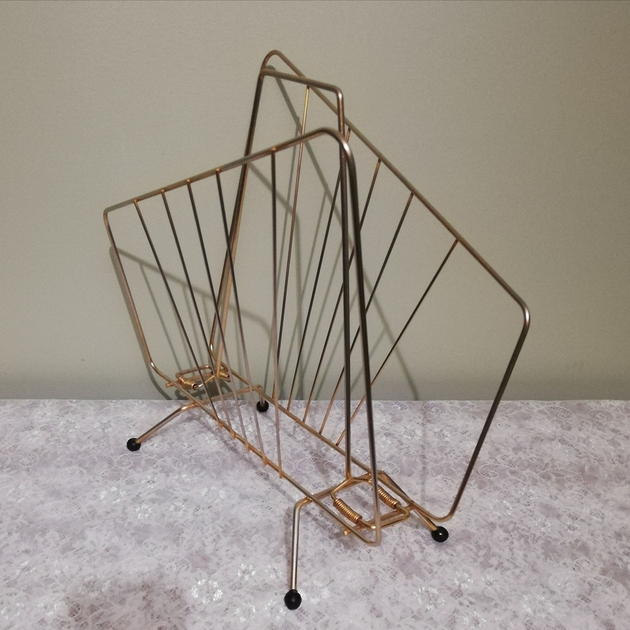 Vintage magazine holder in gilded brass.