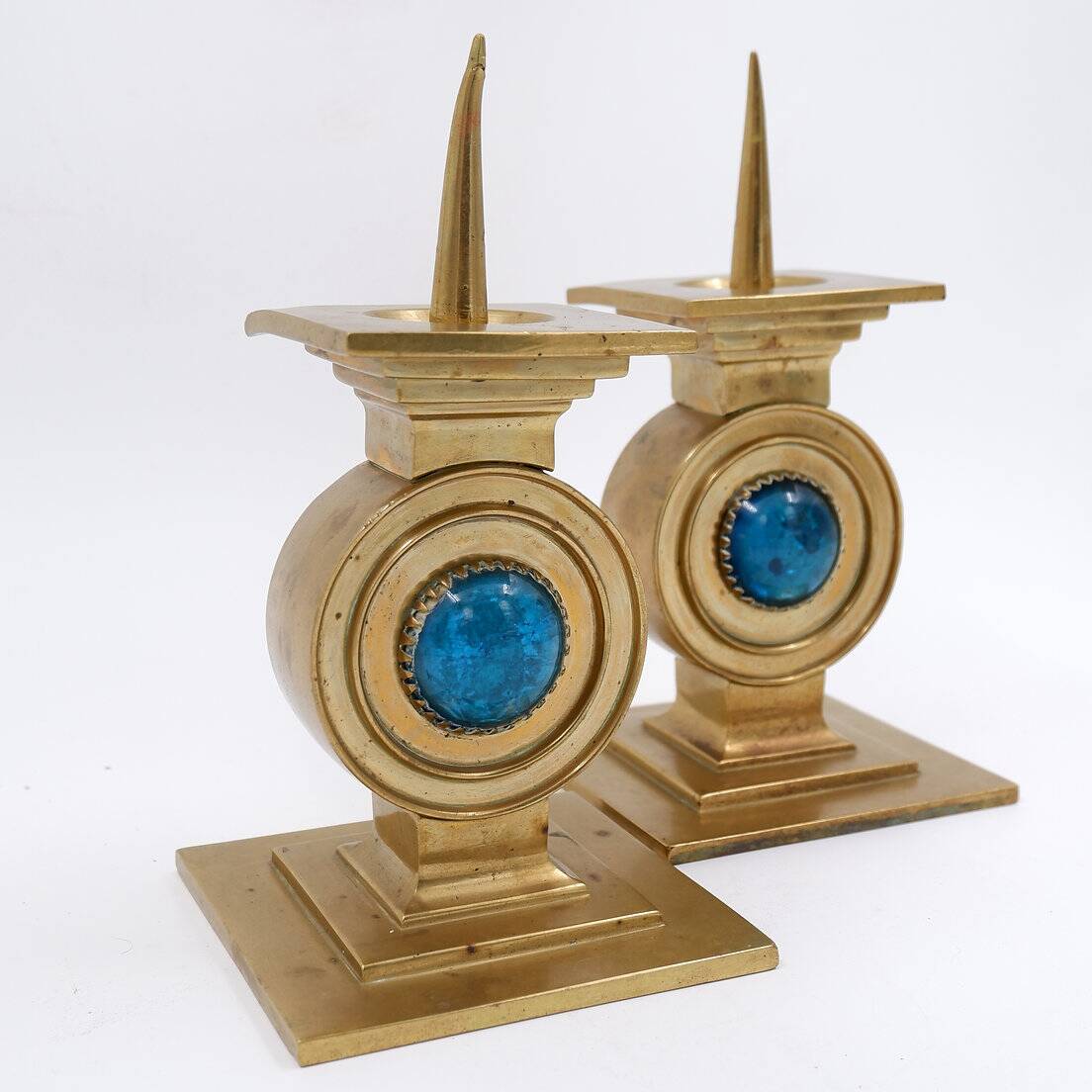 Pair of brass candlesticks decorated with a blue stone inlaid in the center