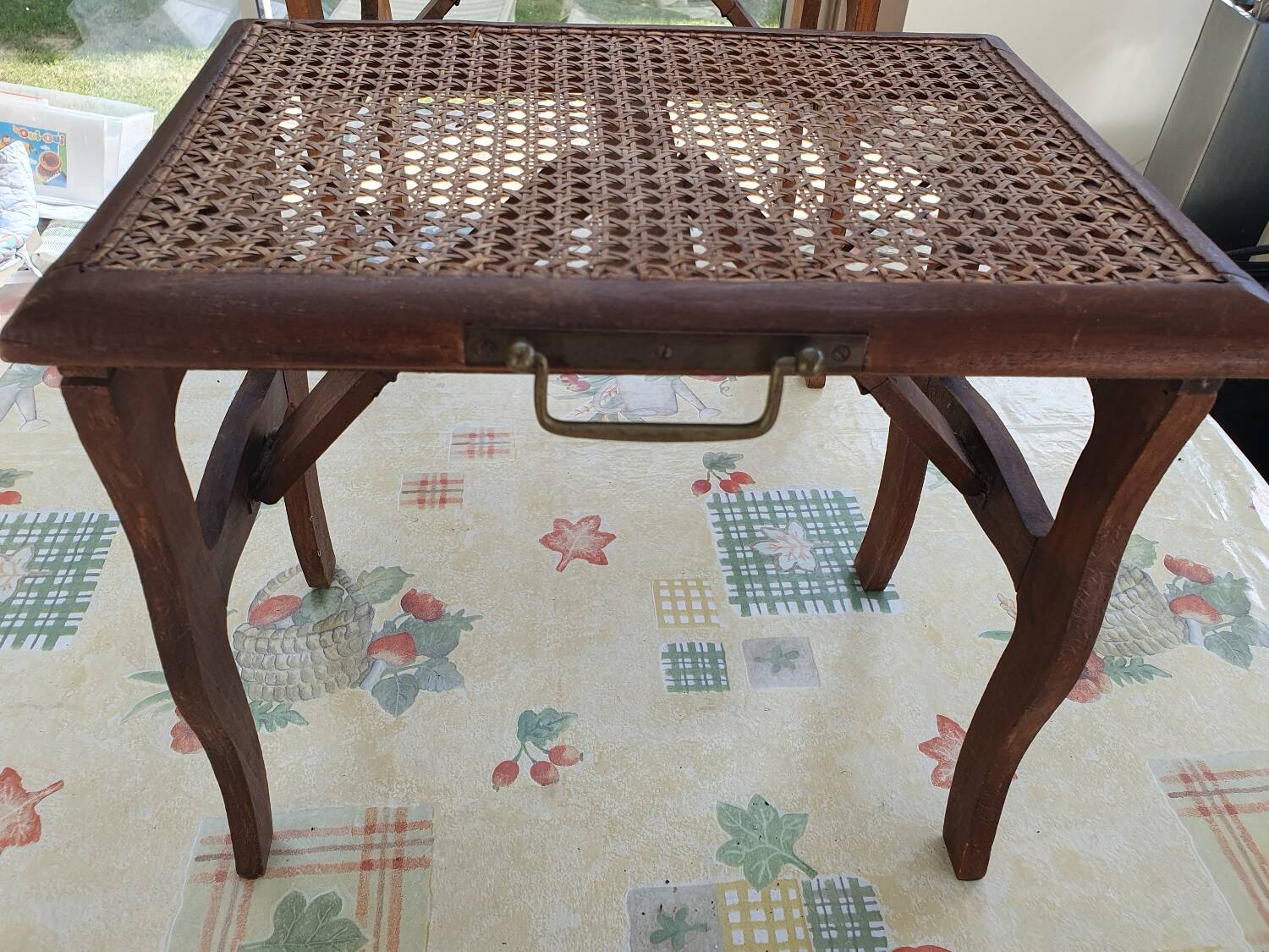 Two folding stools with caned seats.