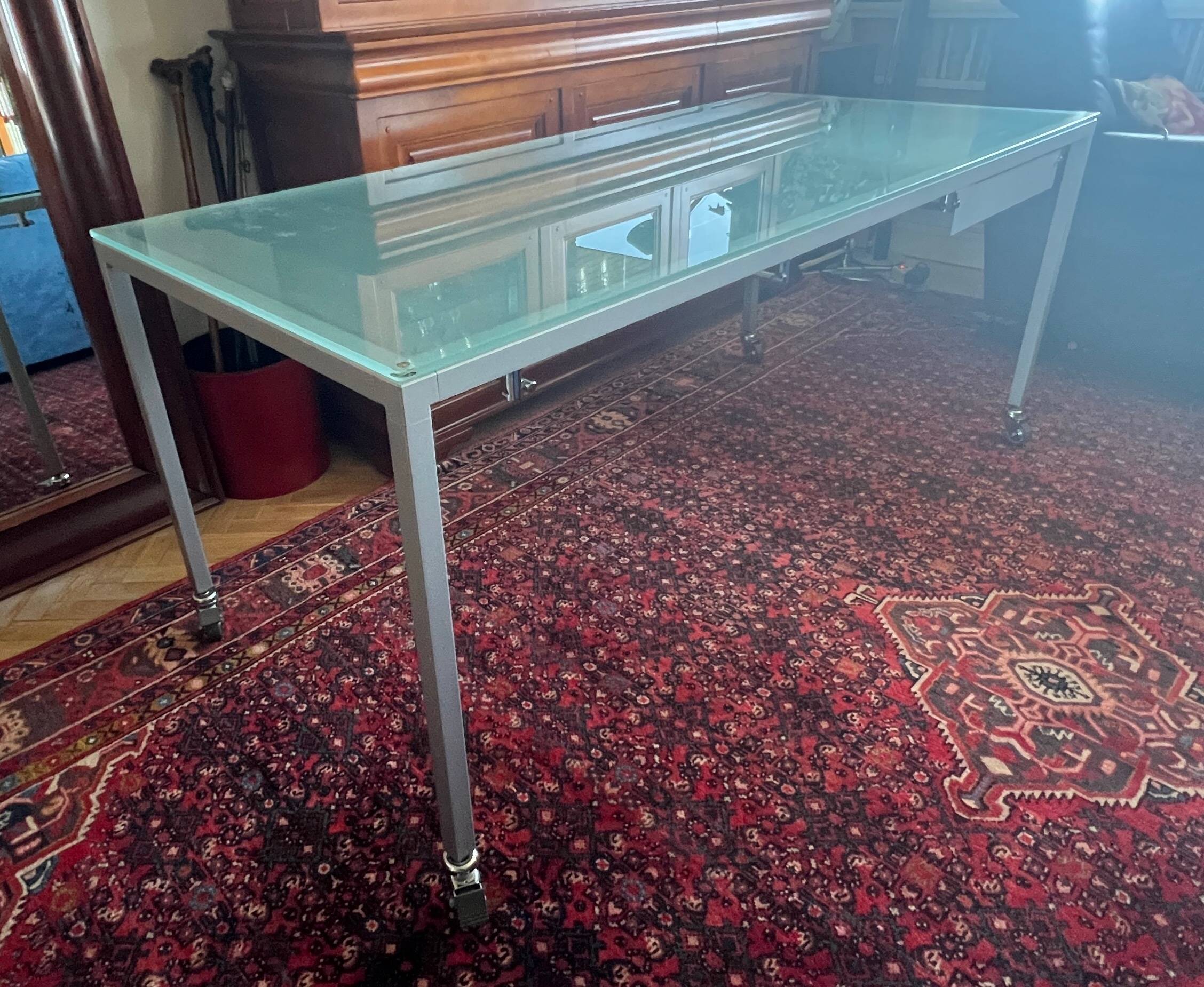 Glass and metal desk with wheels
