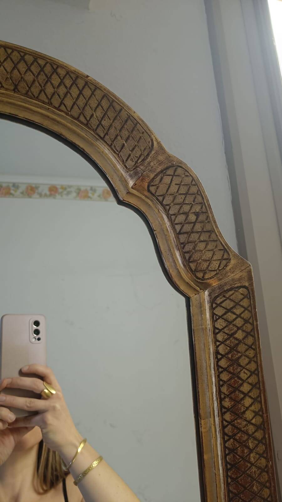 Italian mirror with a sculpted patinated arch, neo-Renaissance style.