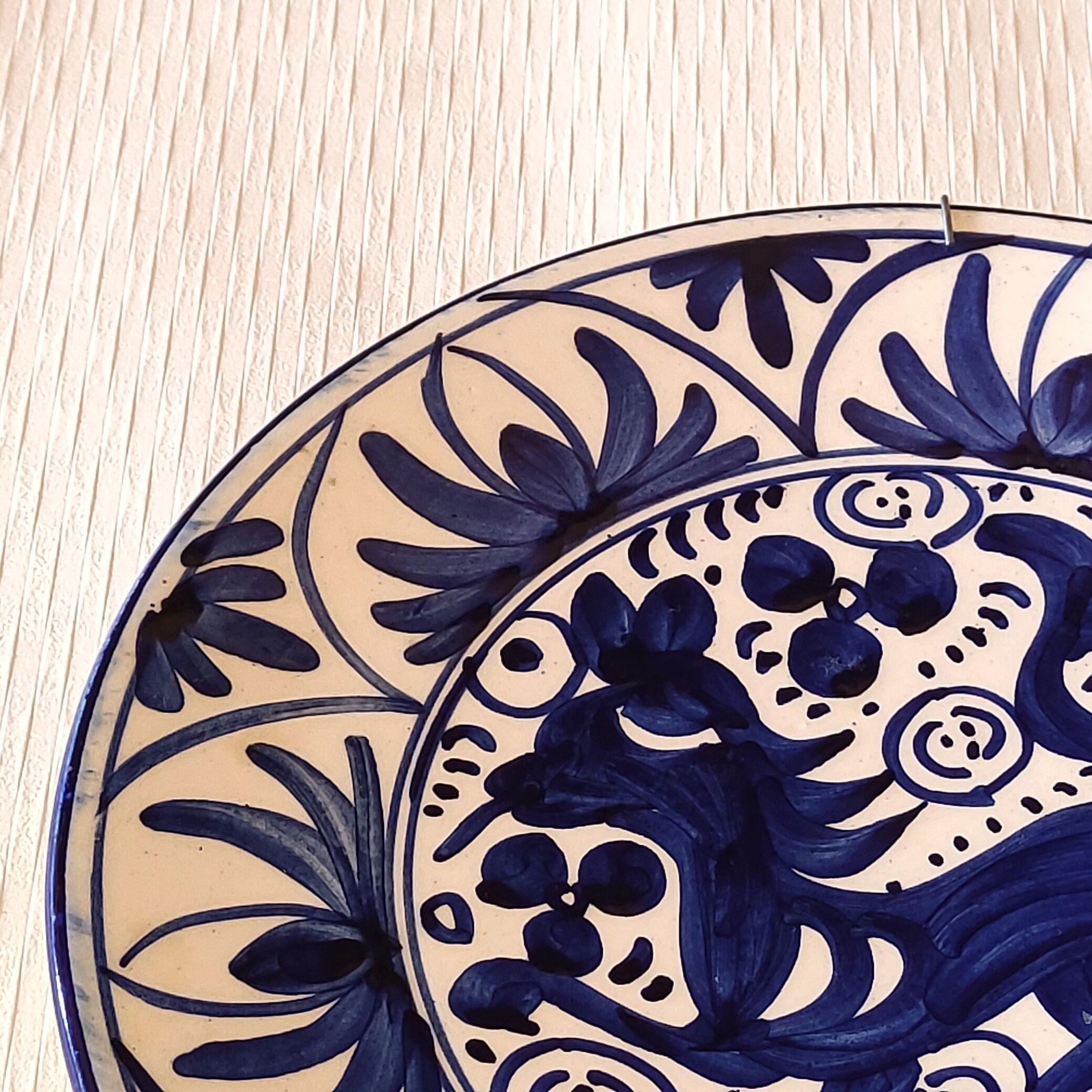 Hand-painted decorative plate decorated with a blue chimera pattern