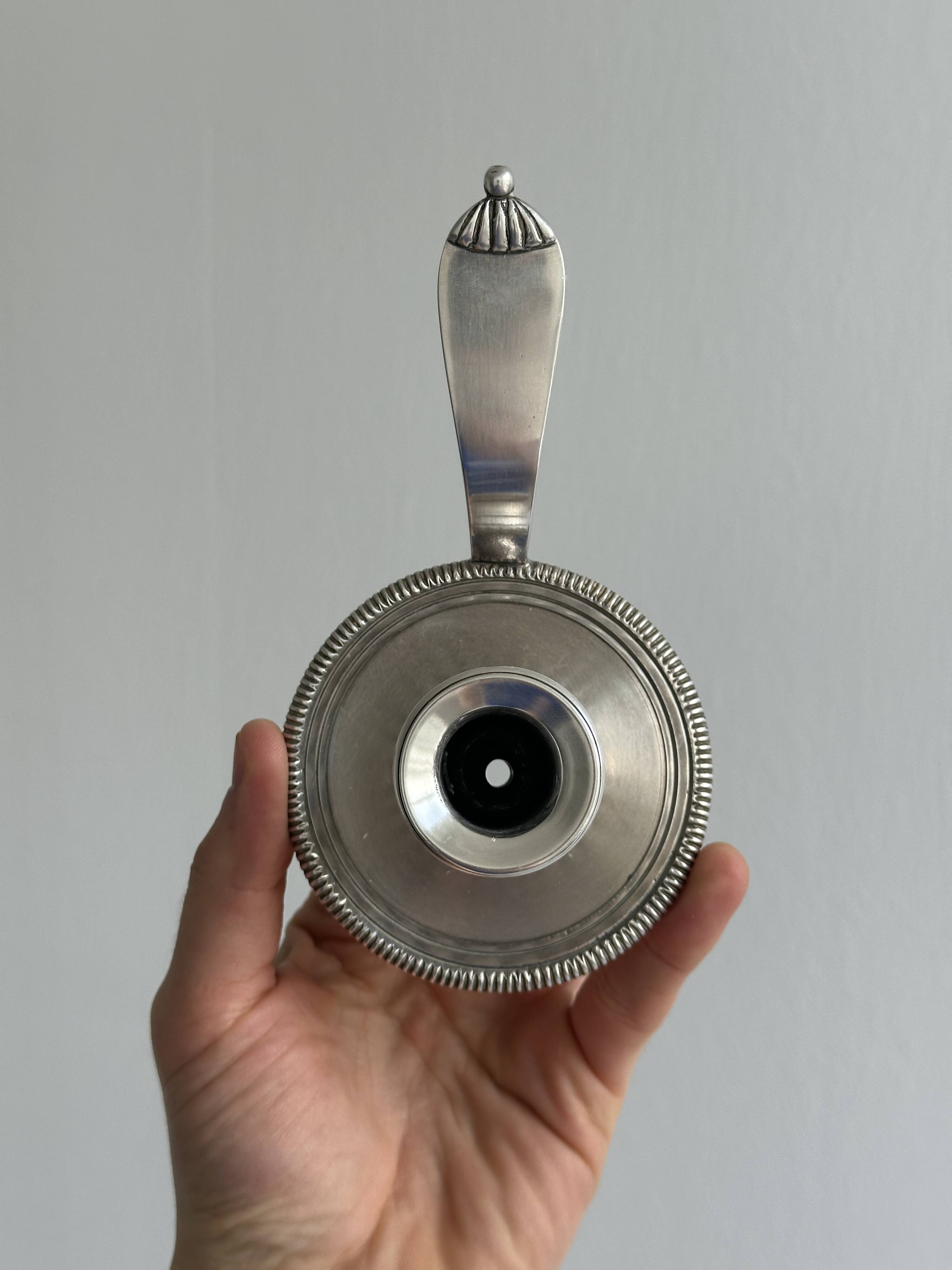 Pair of shiny silver metal candlesticks