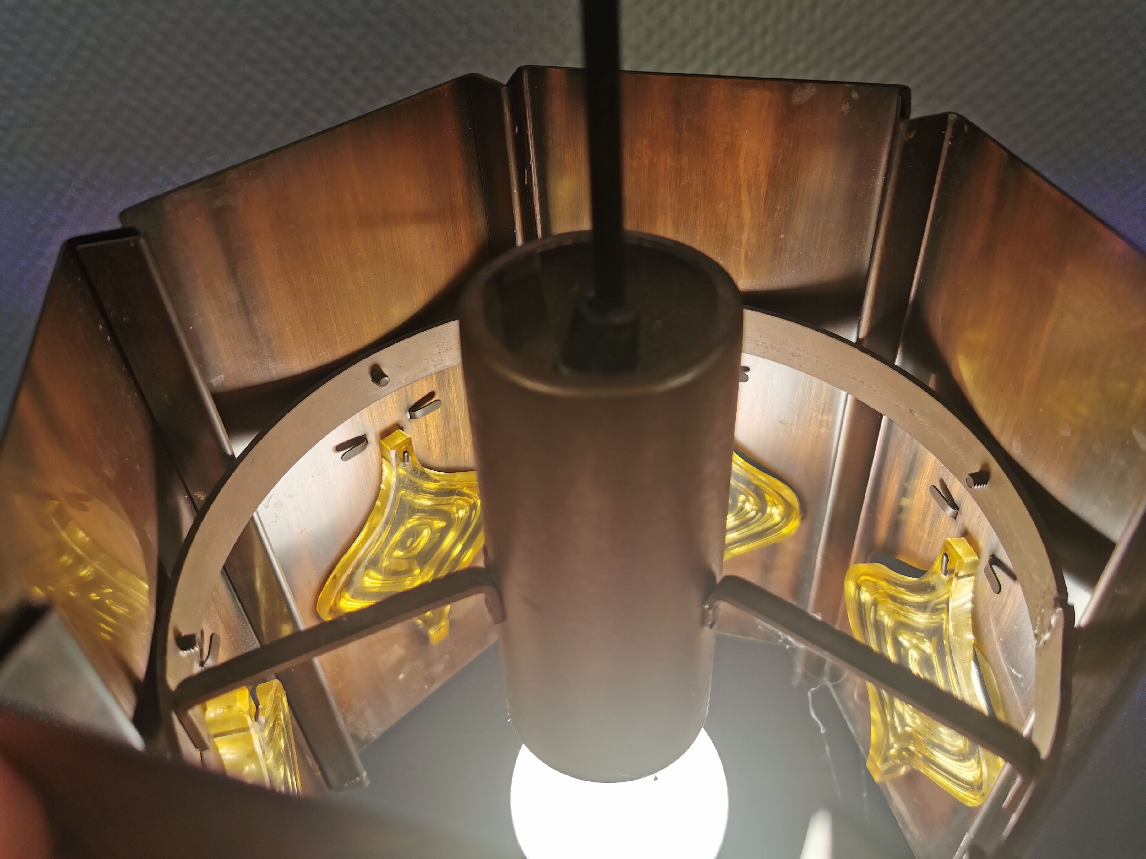 Older hanging lamp, made of metal with yellow prisms.