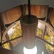 Older hanging lamp, made of metal with yellow prisms.