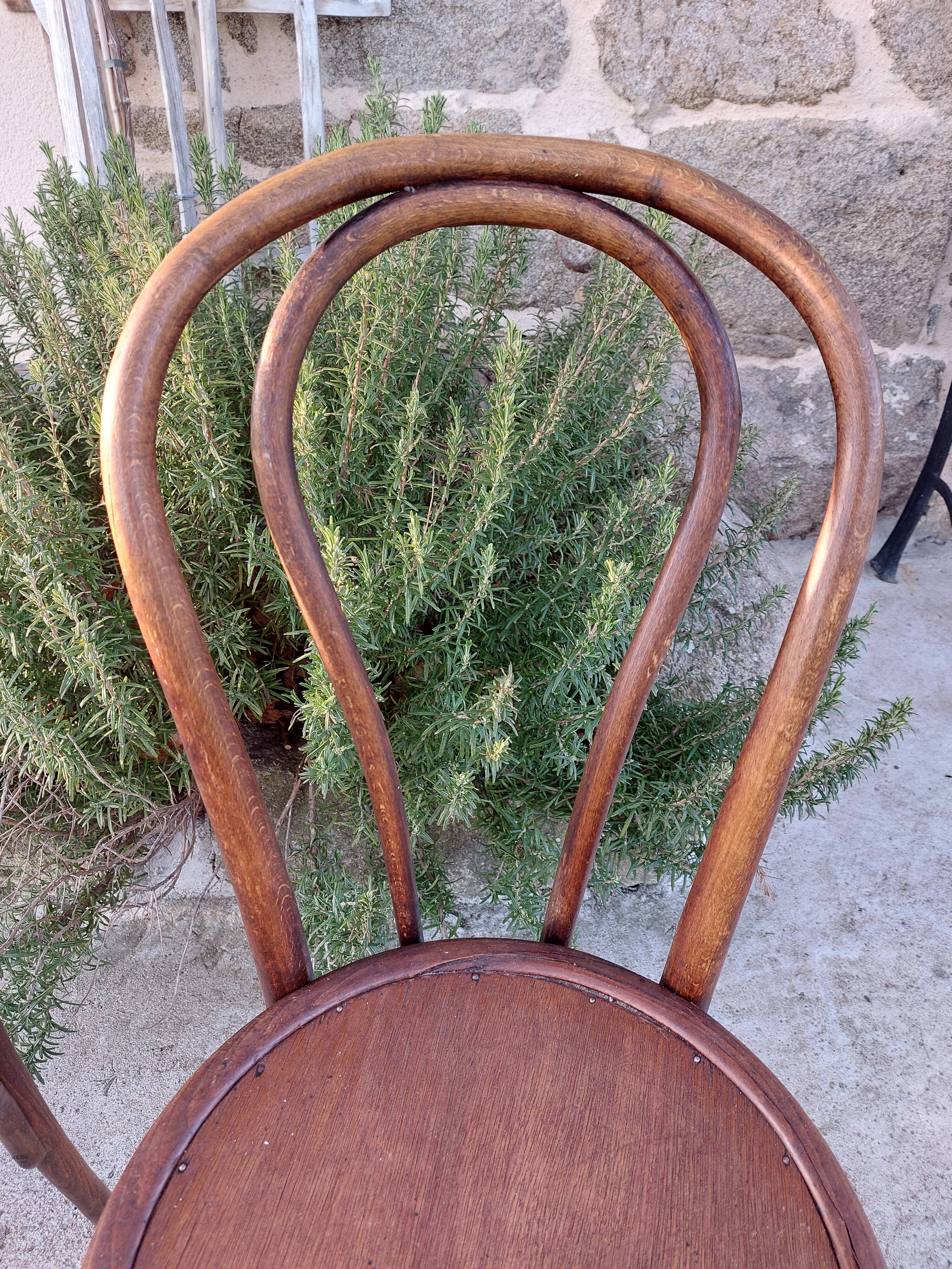 pair of round wooden chairs with a pattern on the seat