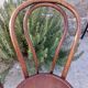 pair of round wooden chairs with a pattern on the seat