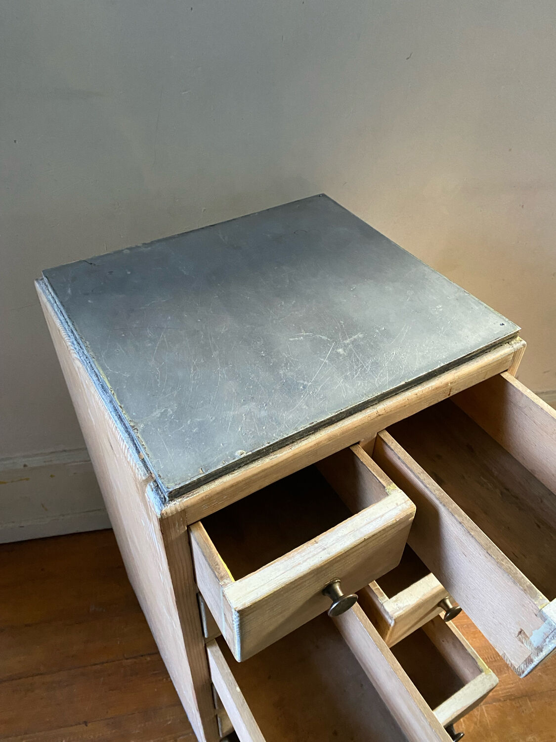 Vintage antique workshop cabinet with 12 drawers in raw wood.