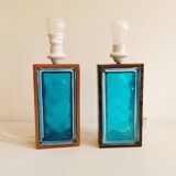 Two Swedish table lamps in solid pressed blue glass and teak wood "frame".