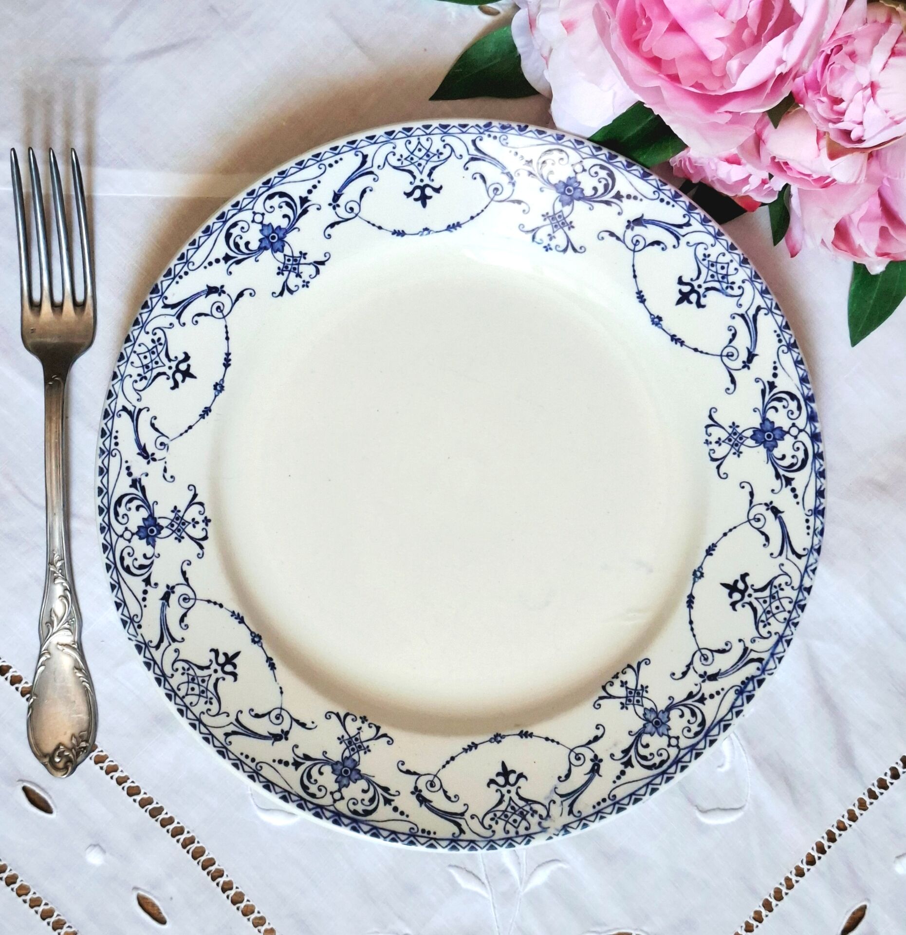 Old mismatched flat plates made of ironstone earthenware.