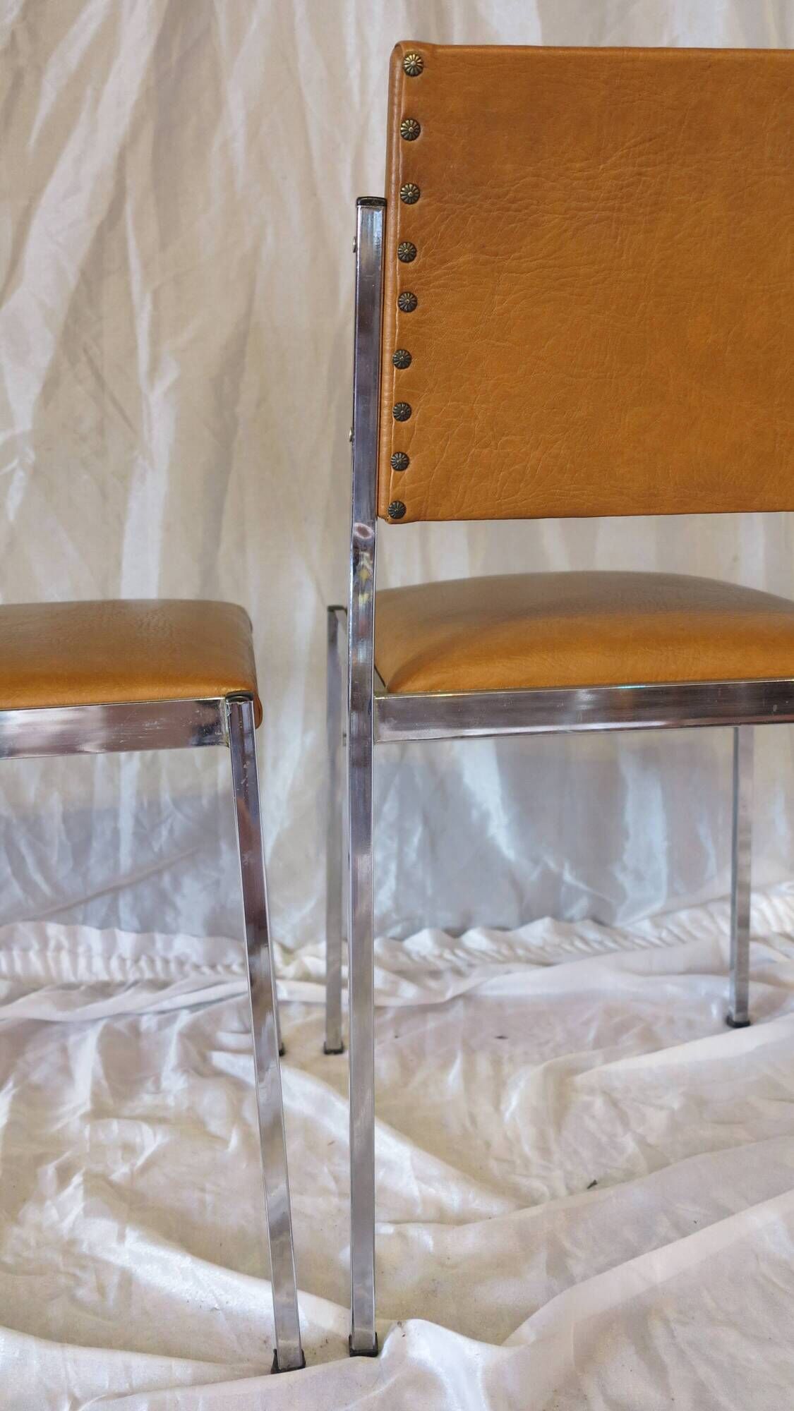 Pair of modernist chairs in chromed metal and imitation leather