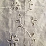 Table service with white handmade embroidery on linen canvas