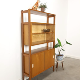 Vintage wooden showcase with sliding doors and white handles