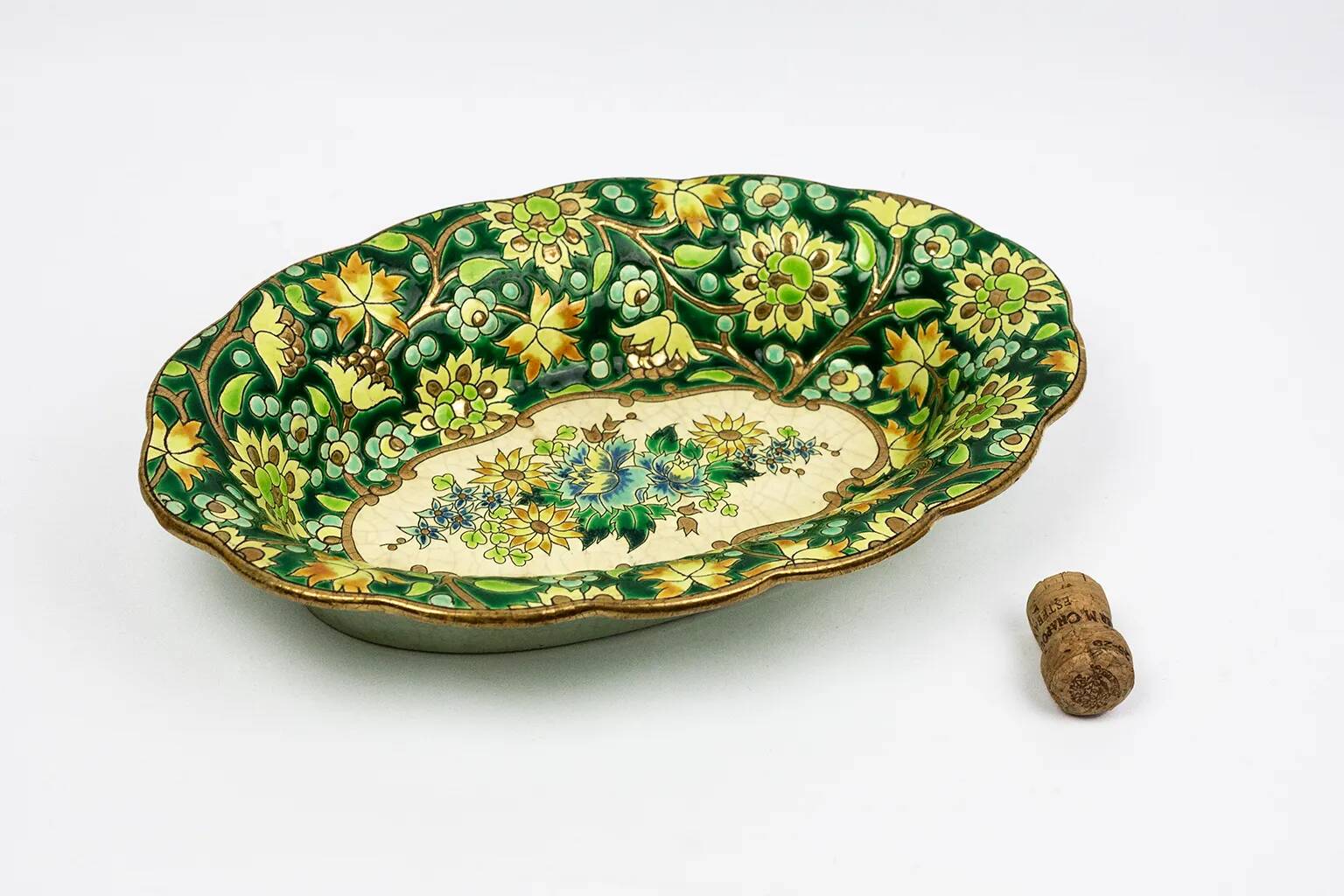 Longwy cup in cloisonné enamels on a green background, polychrome floral decoration and gold