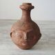 Old anthropomorphic terracotta vase pitcher