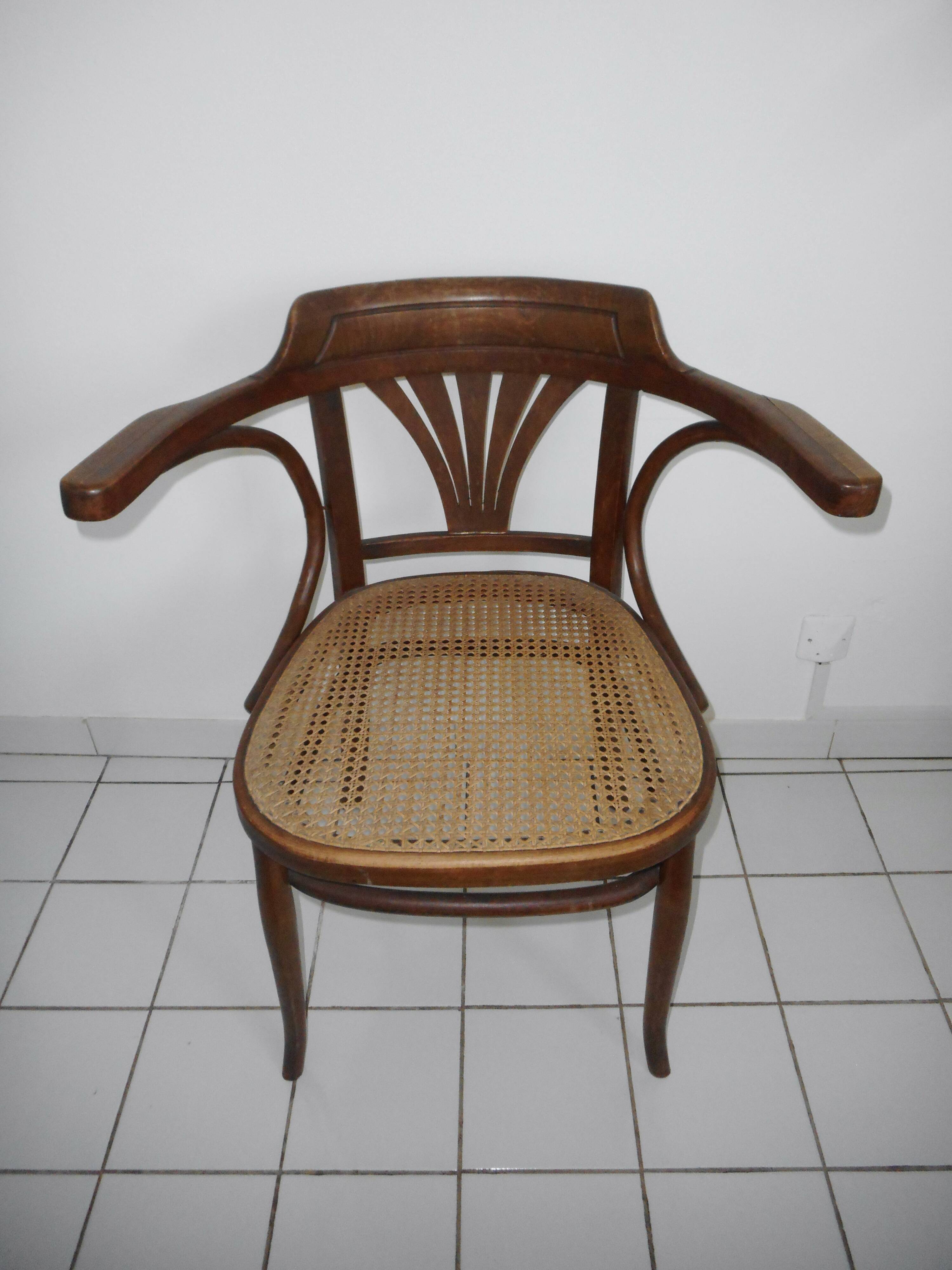 Wooden armchair with caned base