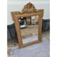 19th-century mirror in gilded wood and stucco.