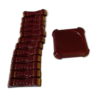 together 12 carries knives and a red enamelled earthenware bottle