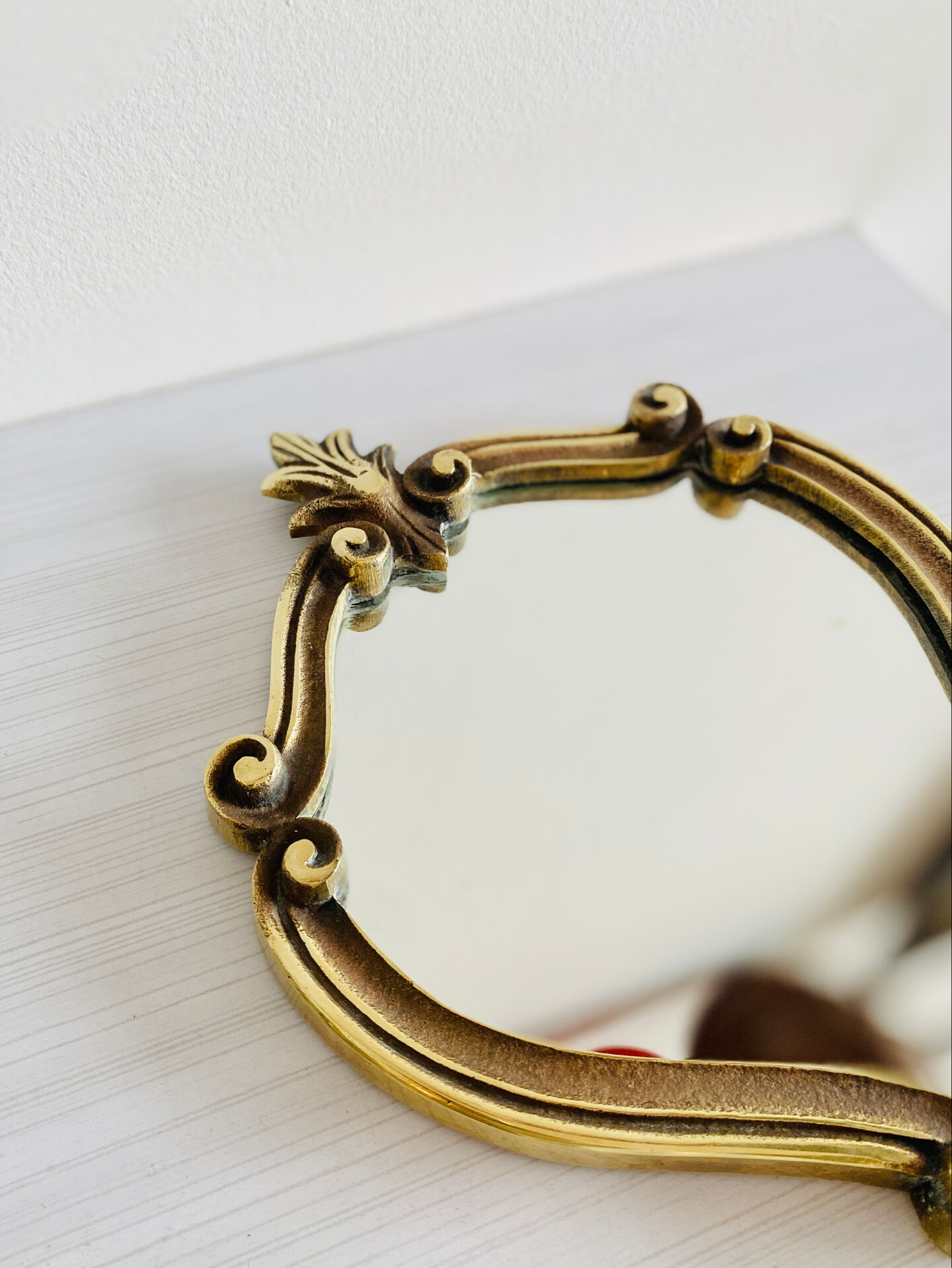 Small antique mirror in baroque style – gold frame in bronze or brass.