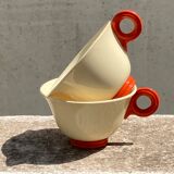 Two old orange handle cups