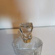 Cut glass carafe with a gold band on the neck.