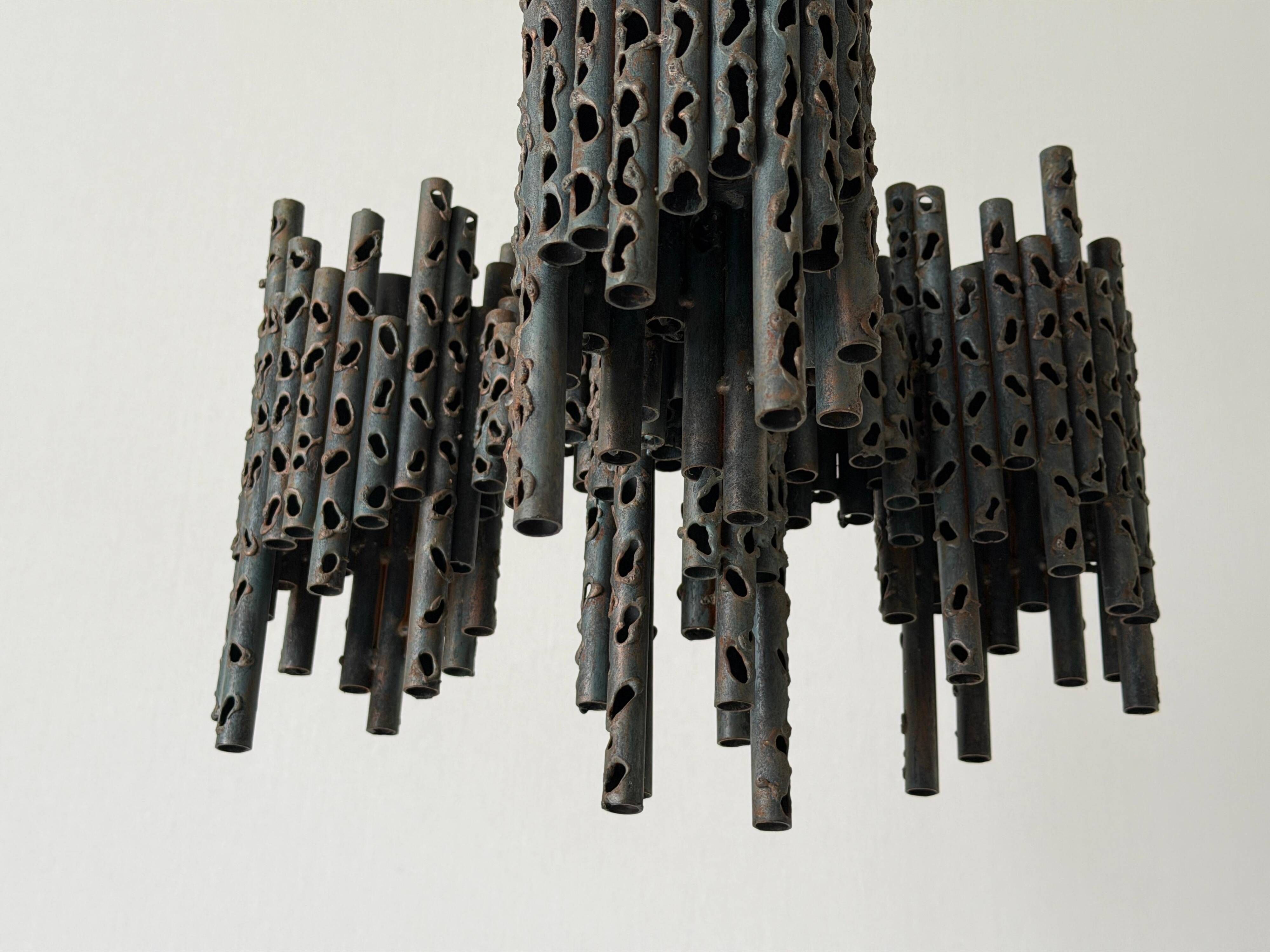 Three-armed suspended lamp in wrought iron, brutalist design, 1960s, Italy.