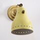 Wall lamp inlaiton and pale yellow lacquered metal