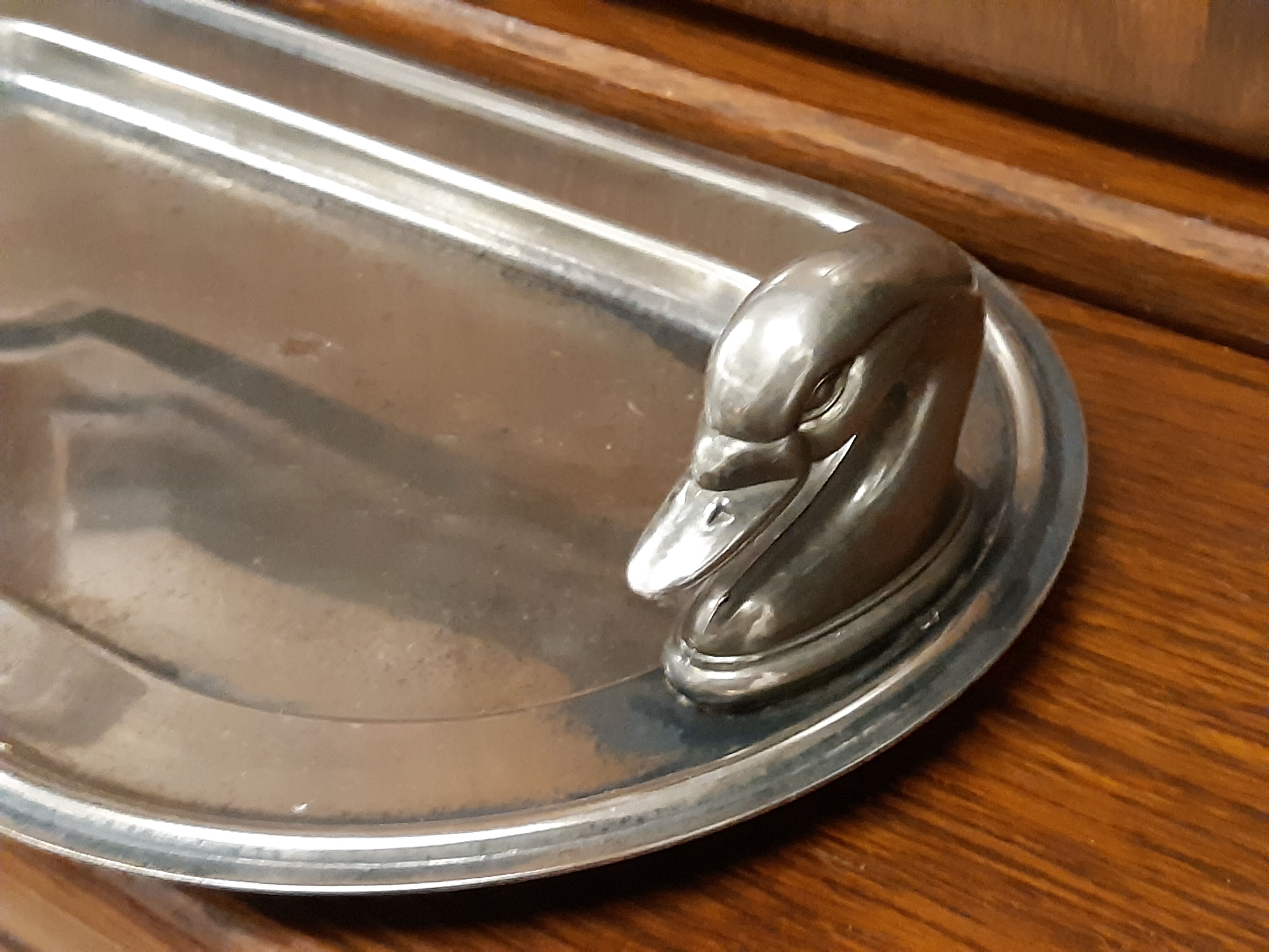 Silver dish with foie gras, duck heads