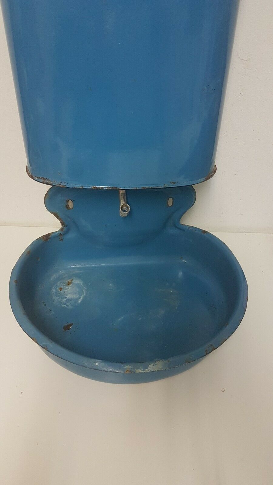 Old hands wash in enamelled sheet metal