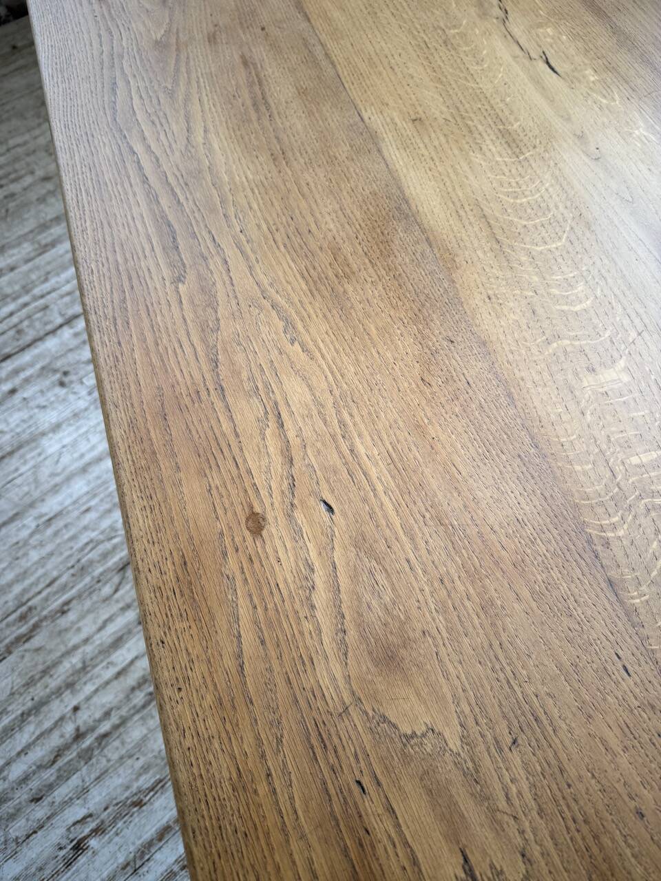 Oak farmhouse table with turned black legs.