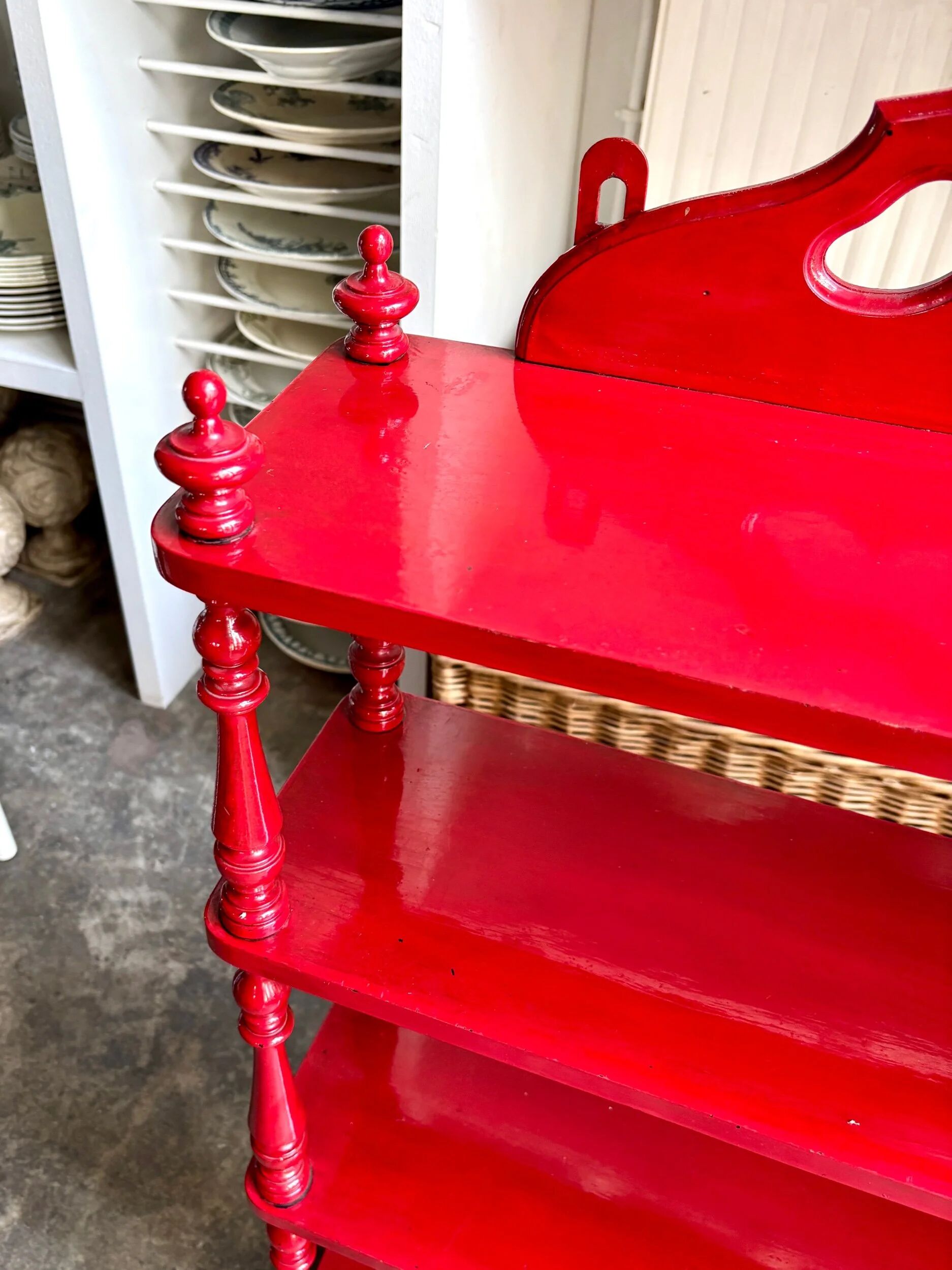 Wall shelf with 4 red lacquered wooden shelves.