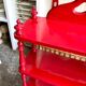 Wall shelf with 4 red lacquered wooden shelves.