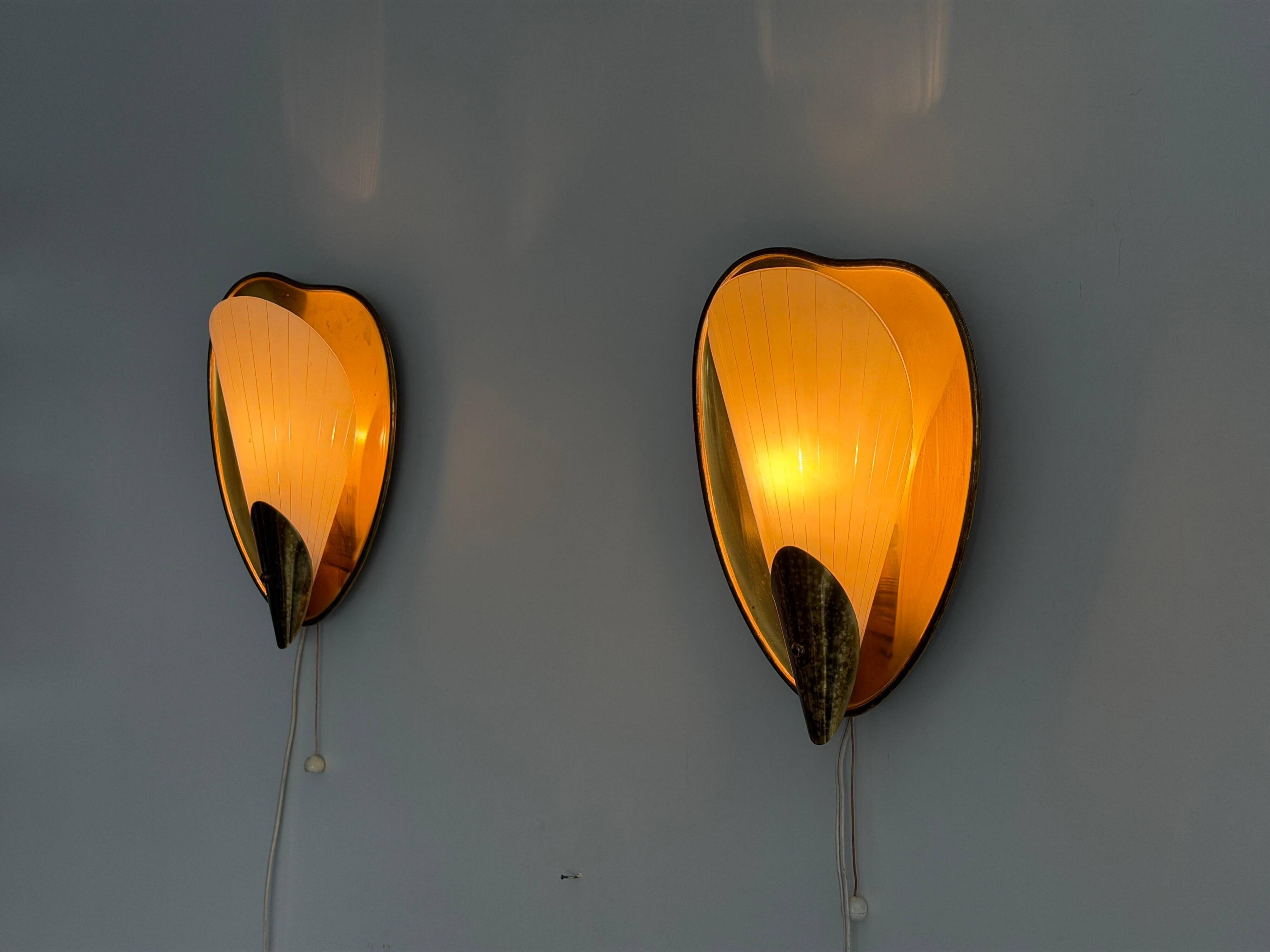 Pair of brass and glass wall lights from the mid-century, 1950s, Germany.