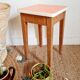 Wooden wax stool and orange formica