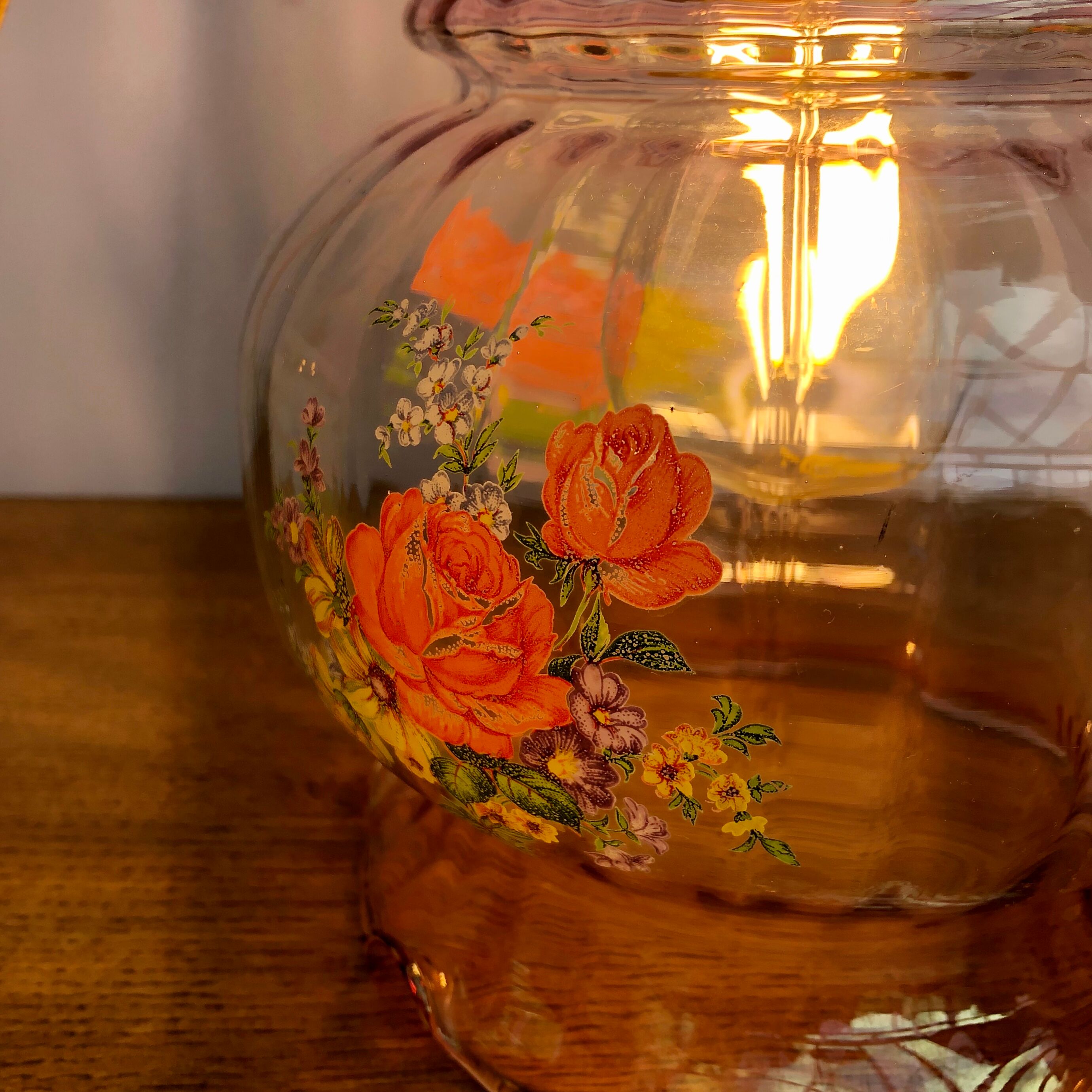 Vintage pink glass hand lamp with flower motifs