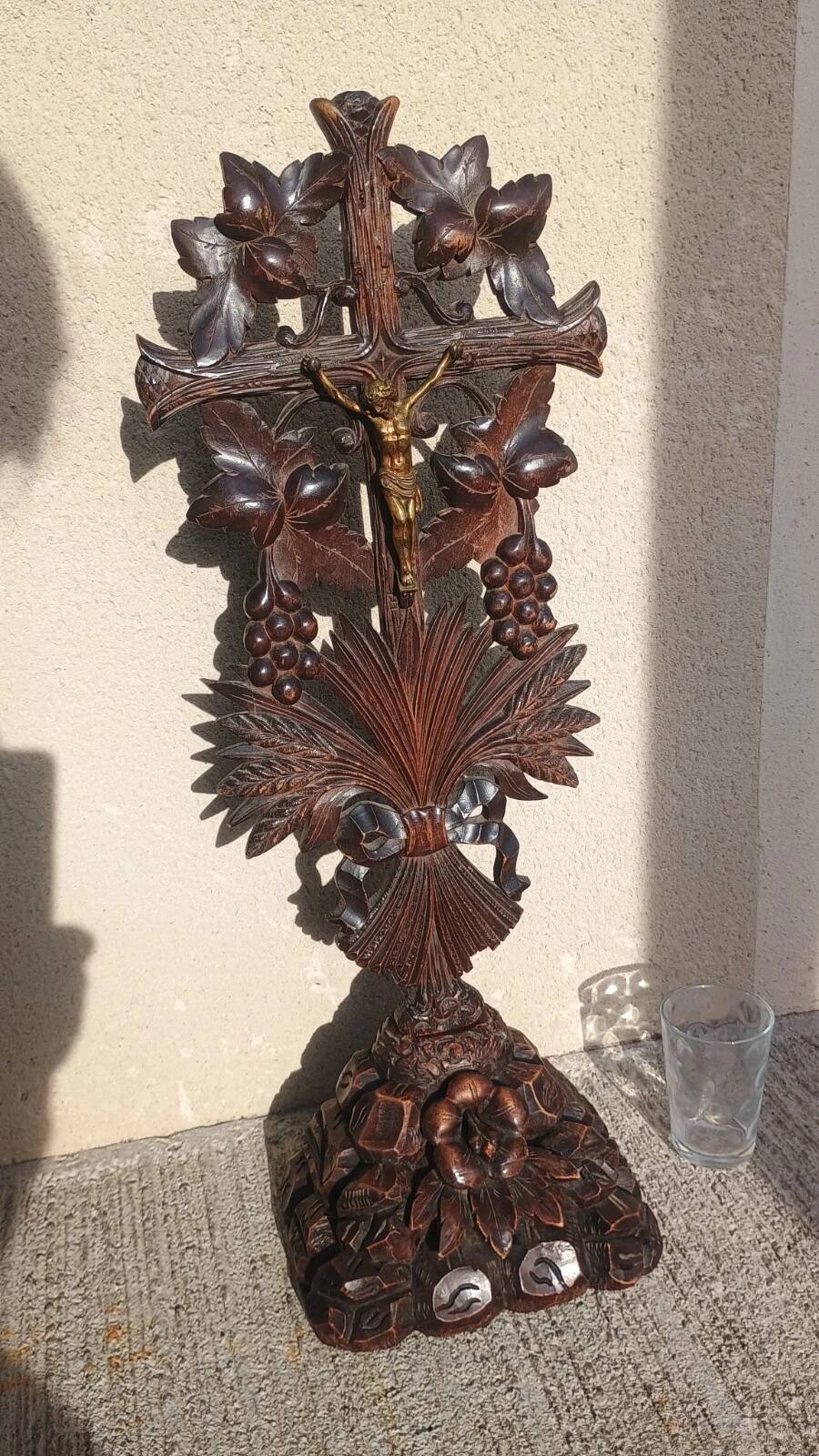Antique wooden crucifix carved from the Black Forest with grapes and leaves.