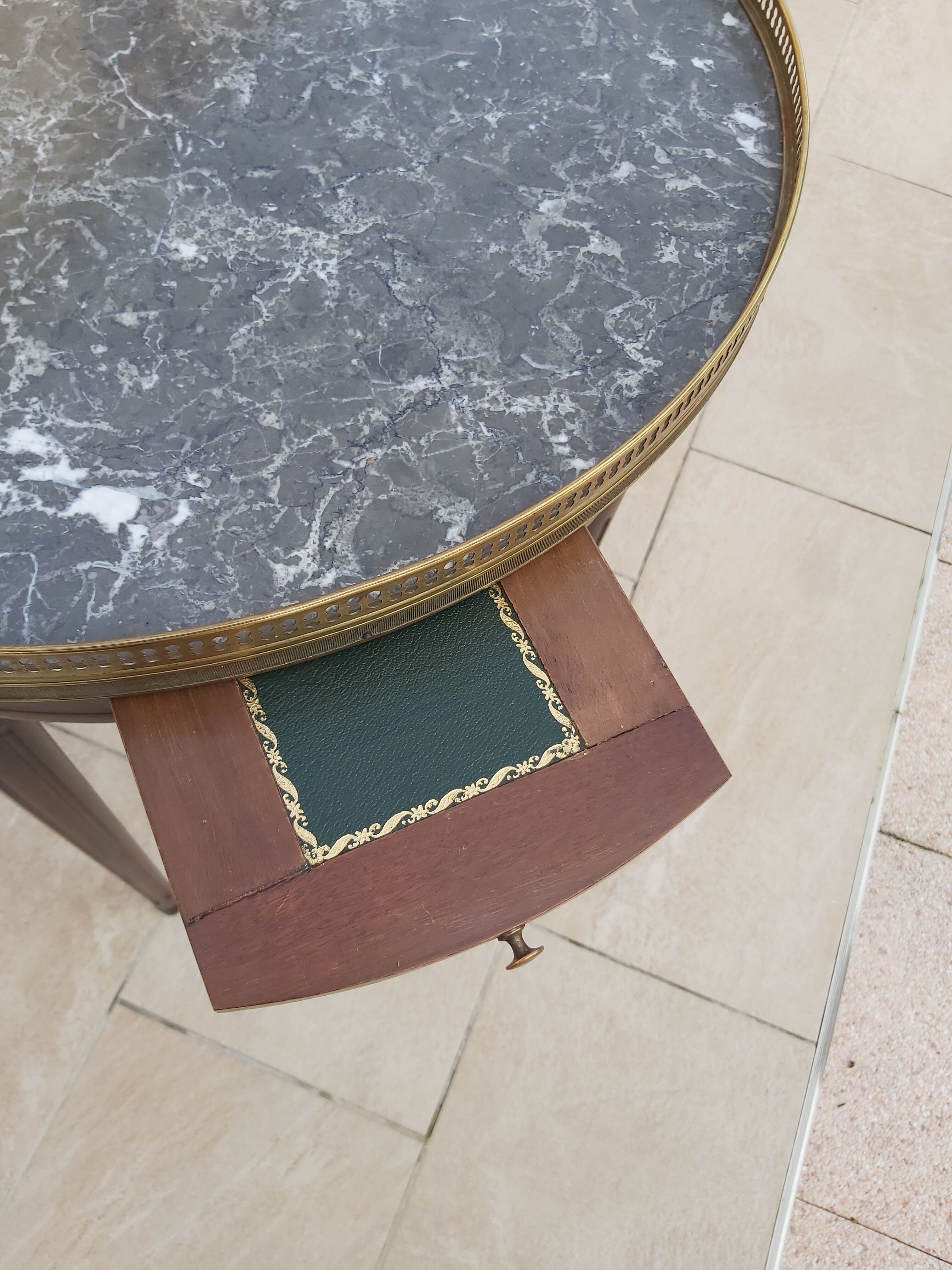 Gray marble mahogany pedestal table and brass gallery