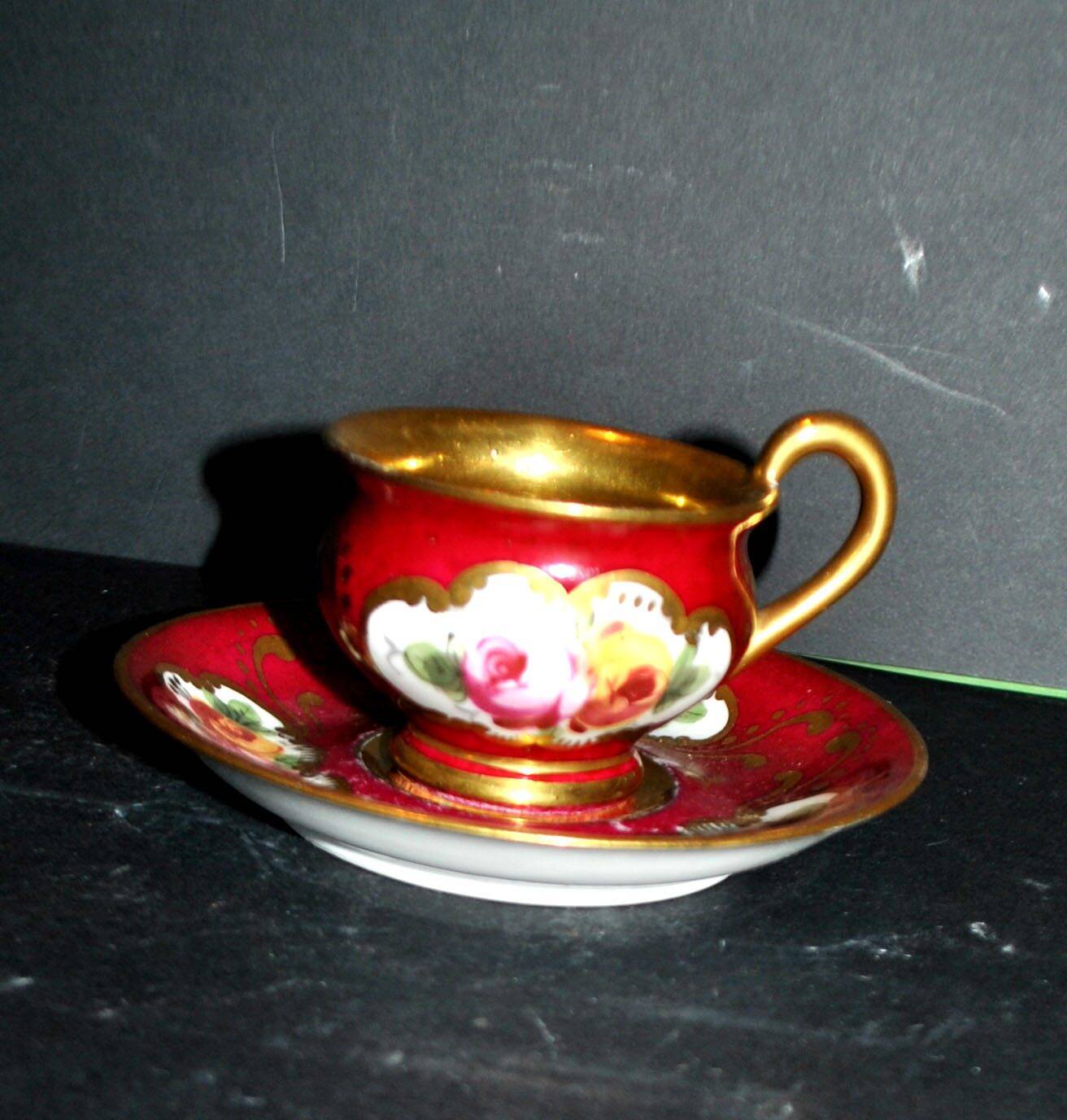 Limoges precious porcelain cup decorated in fuchsia pink and gold, signed MAB