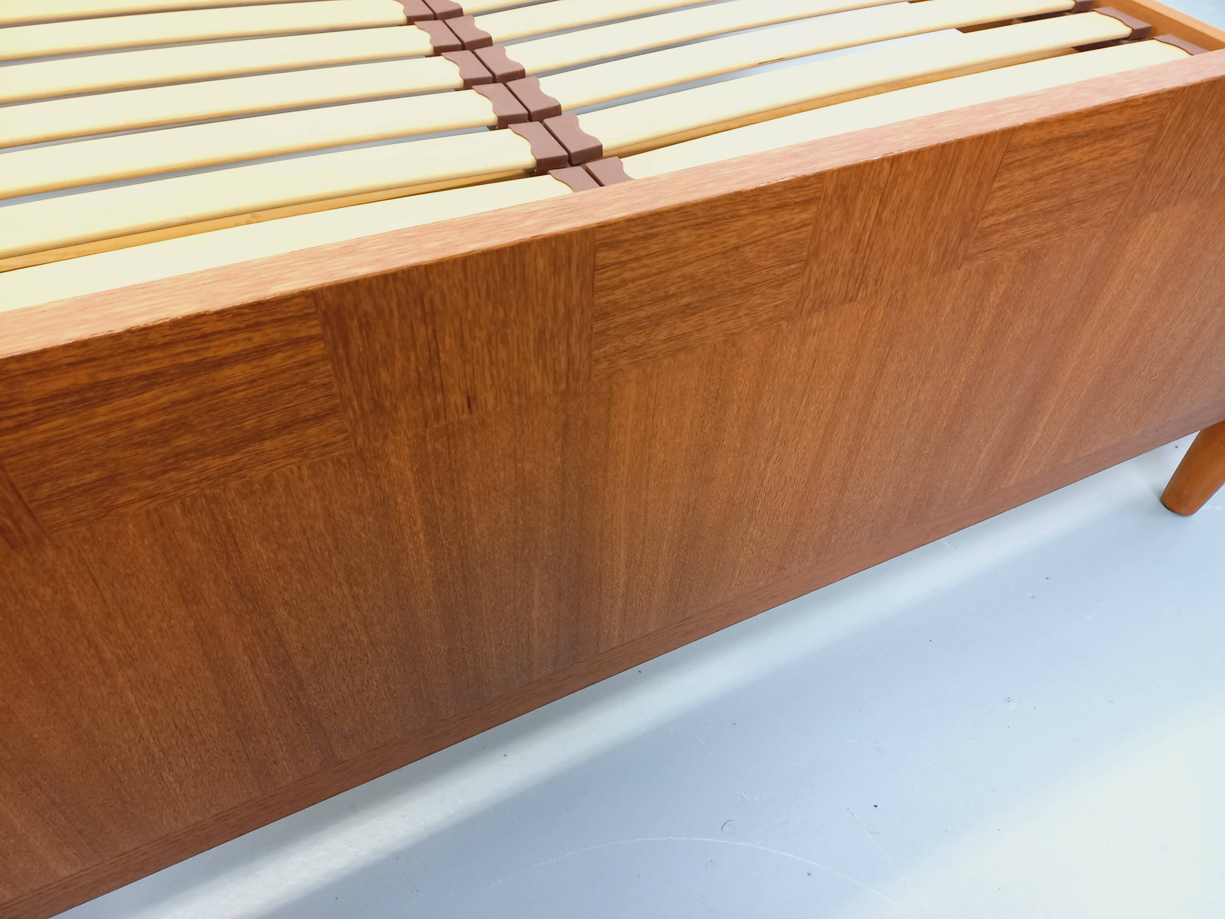 Double bed vintage Scandinavian in teak from the 1960s with integrated bedside tables.