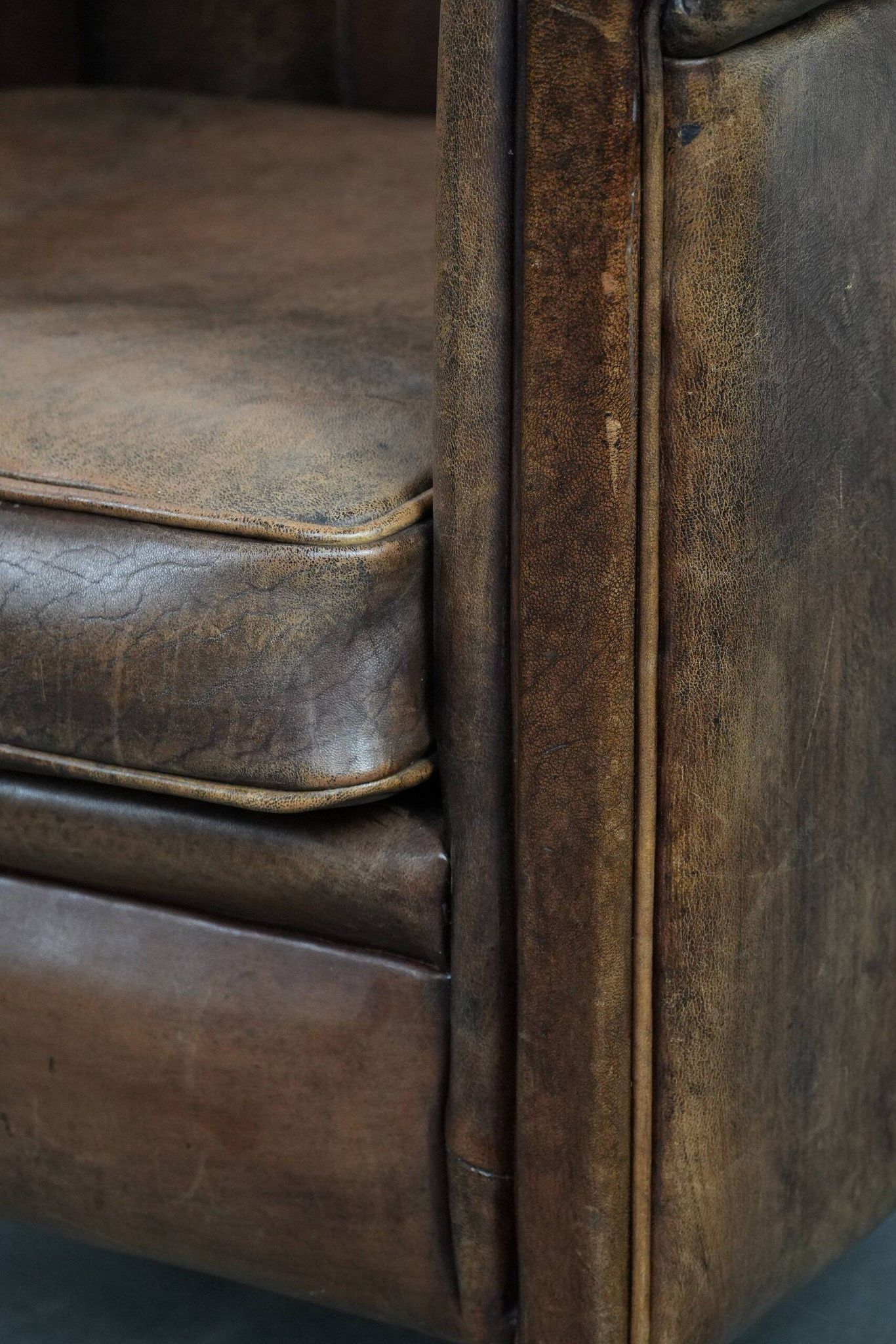 Vintage sheepskin armchair with warm colours and a characterful appearance