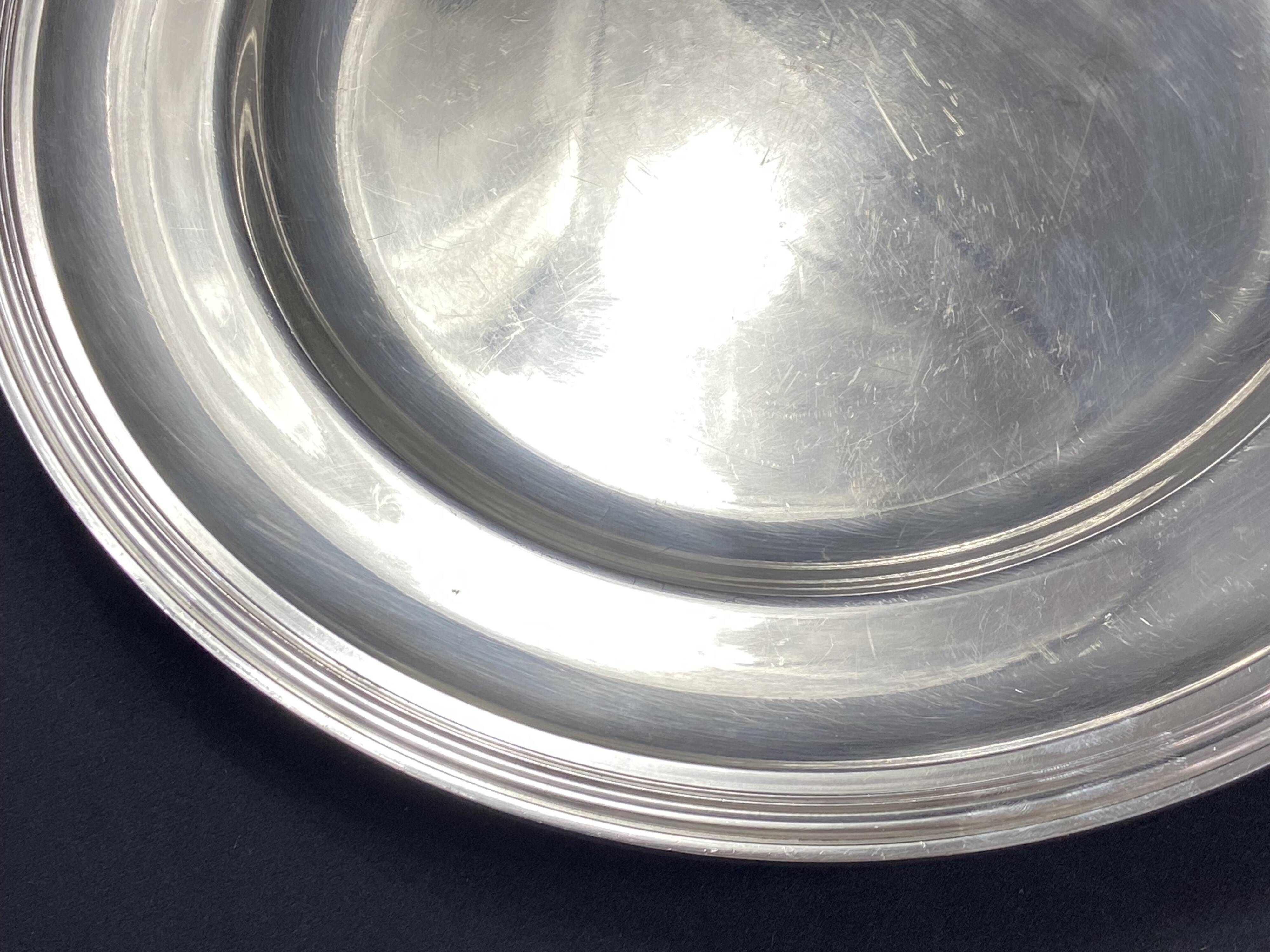 Circular silver-plated metal dish signed ercuis
